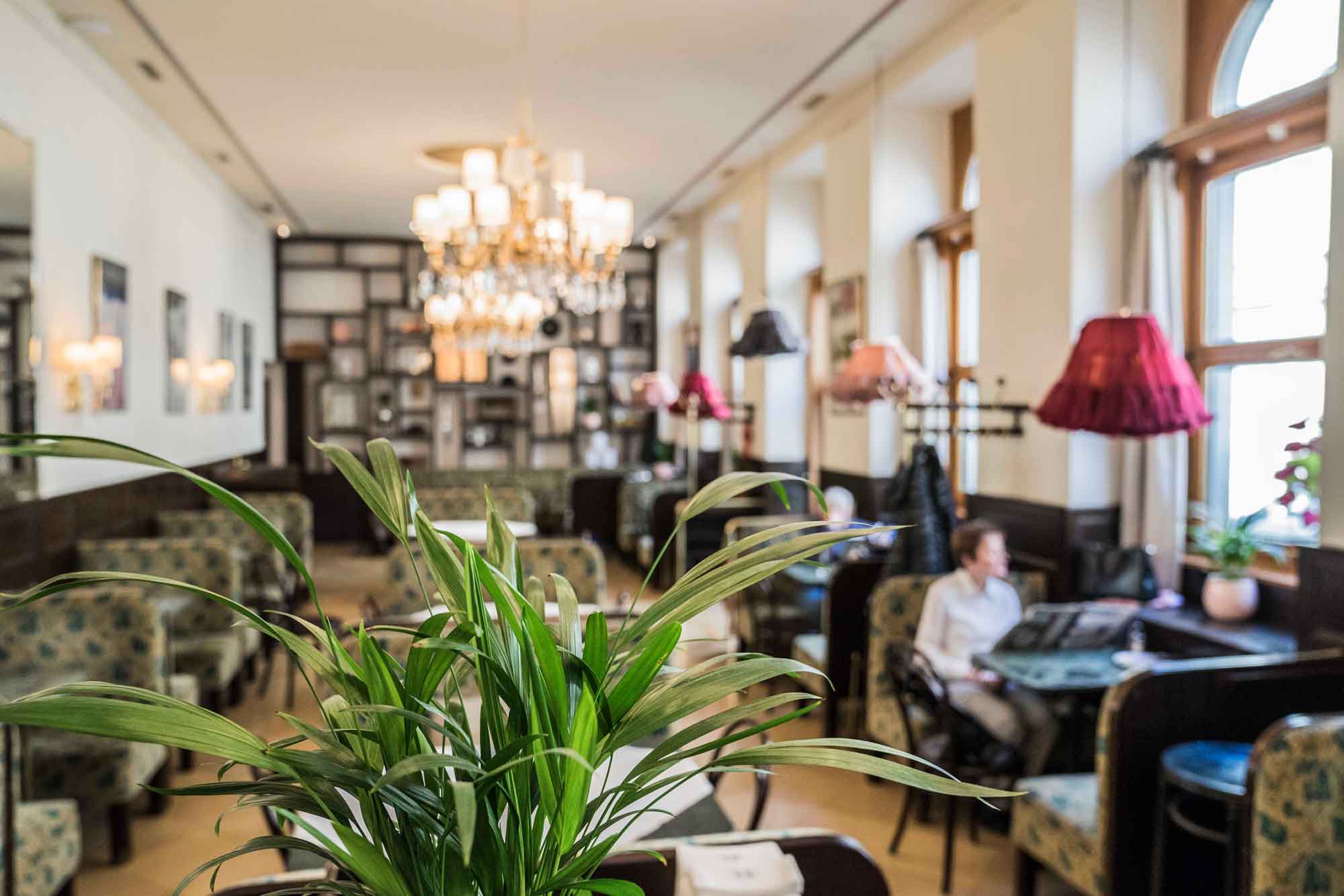 Chandeliers, tall windows and traditional seating in the Café Weimar restaurant